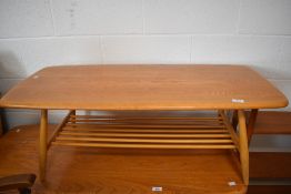 An Ercol light elm coffee table, of oblong form with rounded corners and spindled under tier, 36cm x