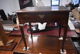 A George III oak side table, of rectangular form with single drawer raised on turned cabriole type