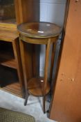An Edwardian mahogany palm stand, of circular form with slender square section supports, flared at