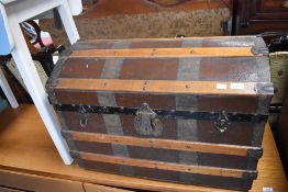 A domed and ribbed travel trunk with painted metal mounts and vacant interior 50cm x 72cm x 40cm