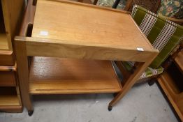 A 1970's/80's teak tea/drinks trolley, of traditional design 68cm x 70cm x 43cm drawer front with