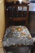 A Victorian oak dining chair and two canework footstools