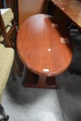 A reproduction mahogany effect oval coffee table 49cm x 118cm