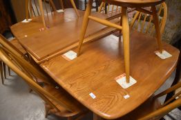 An Ercol extending table approx. Width 90cm, length approx. 153cm, plus two leaves approx 35cm each