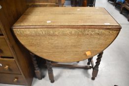 A mid 20th century barley-twist oak drop-leaf gale-leg table 75cm x 75cm x 40cm closed.