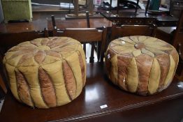 Two vintage leather pouffes, of circular form with stylised flowerhead design, 26cm x 43cm wear