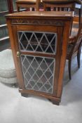 A composite music cabinet in the 19th Century style with lead style glass door, height approx.