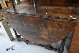 A 19th Century oak gateleg dining table having turned frame, width approx. 122cm