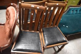 A set of four 1940's oak dining chairs, having simple slatted backs and turned supports, seat height