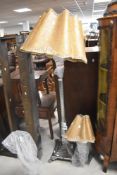 A chrome Corinthian column standard lamp and two similar table lamps