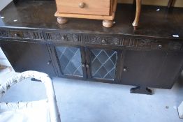 A vintage Old Charm style sideboard base having glazed section