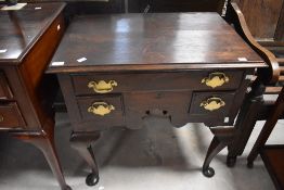 A George III oak lowboy, the moulded rectangular top above one long and two short drawers, each with