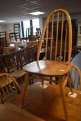 A set of eight Ercol hoop and stick back kitchen chairs , stamped to underside 1960-2056, having 'H'