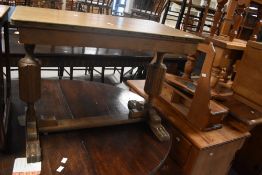 An early 20th Century faded oak occasional coffee table in the Priory style, width approx. 69cm