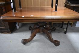 A 19th century mahogany breakfast table, of moulded rectangular form over a carved and turned column