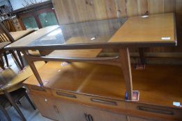 A vintage teak and glass top coffee table possibly G plan having stylised frame and solid undertier,