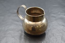 A George V silver Keswick School of Industrial Arts silver cream jug, of circular bulbous form