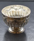A Victorian silver bowl, having a moulded rim with floral and bow swags over a half gadrooned