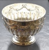 A Victorian silver bowl, having a moulded rim with floral and bow swags over a half gadrooned