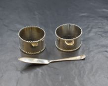 A pair of cased George VI silver napkin rings, having decorative rims, marks for Birmingham 1938,