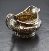 A William IV silver sauce boat, of circular bulbous form, having a moulded rim and generous spout