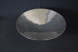 A large Elizabeth II silver fruit bowl, of circular form having planished decoration and