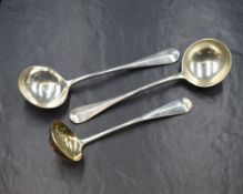 A pair of Edwardian silver Hanoverian rat-tail pattern sauce spoons, along with a matching sugar