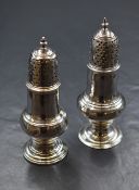 A George III silver pepperette of bulbous form having a heraldic crest and S initial engraved,