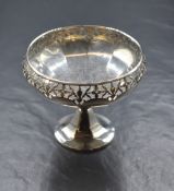 A George V silver pedestal bonbon dish, of circular form having a moulded rim, pierced sides, and