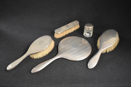 A George V silver mounted vanity pair, comprising a hairbrush and clothes brush, with honeycomb