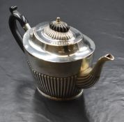 A late 19th/early 20th century silver teapot, of oval form having a narrow spout opposed by a c-