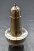 A George V silver sugar caster, the pointed finial over a pierced top on a circular bulbous body,