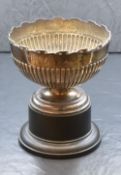 An Edwardian silver trophy bowl, having a scroll rim and half gadrooned body, raised on a circular