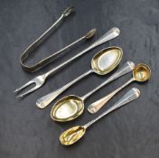 An assortment of Edwardian silver Hanoverian rat-tail pattern condiment and salt spoons with