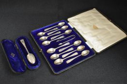 A cased set of twelve George V silver Old English pattern teaspoons, having decorative engraving
