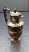 A Victorian silver coffee pot, of circular form having a narrow spout opposed by an angular handle