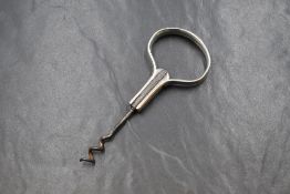 An Irish silver handled cork screw, having a boar head engraved to the handle and monogram to the