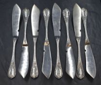 A set of eight Christofle silver plated Marly pattern fish knives, having shell and scroll