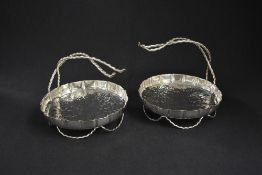 A pair of silver plated serving dishes, of circular lobed form having planished decoration, raised
