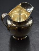 An impressive George V silver jug, of traditional form having a moulded rim and generous spout