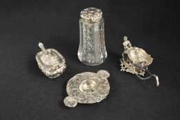 A Victorian silver novelty salt, depicting a man pushing a sleigh with scrollwork to the edges,