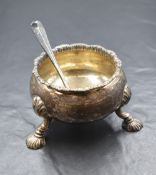 An Edwardian silver sugar bowl, of circular form having a gadrooned style rim, raised on three