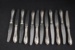 A set of twelve 19th century German white metal 800. grade handled dessert knives, having thread and