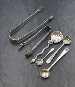 A pair of Georgian Irish silver sugar tongs, having decorative engraving and heraldic crest of a