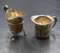 An Edwardian silver cream jug, of traditional form having a Chippendale style rim, generous spout
