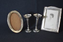 A pair of early George V silver fluted vases, of traditional form having flared rims raised on