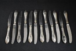 A set of twelve 19th century German white metal 800. grade handled knives, having thread and