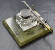 A late 20th/early 21st century silver mounted glass inkwell, of square form raised on a square
