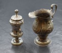 A George III silver jug, of bulbous form having a Chippendale style rim, generous flattened spout