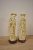 A pair of 20th-century Chinese carved resin imperial figures depicting an emperor and empress,
